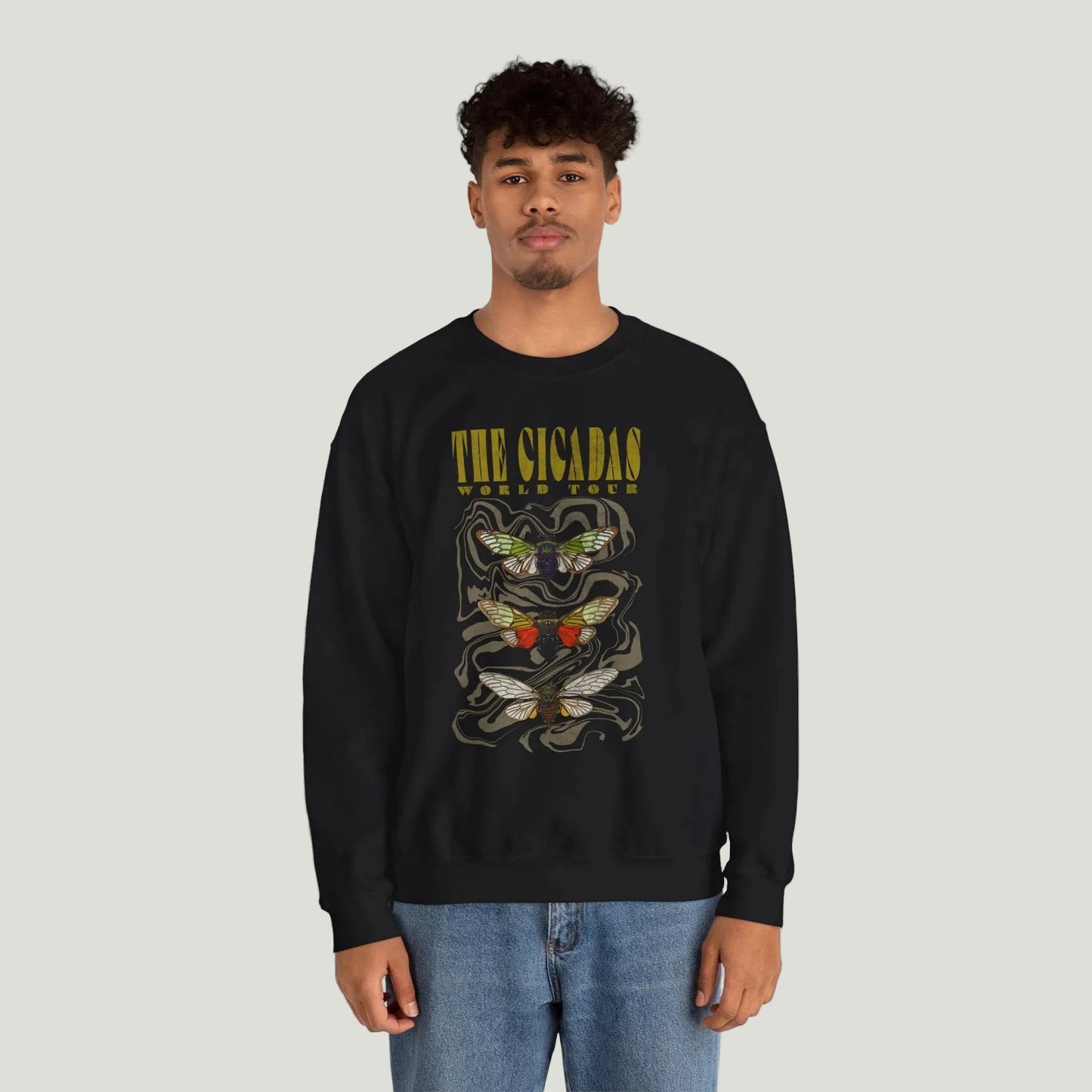 Person wearing a black sweatshirt with gold text on a white background