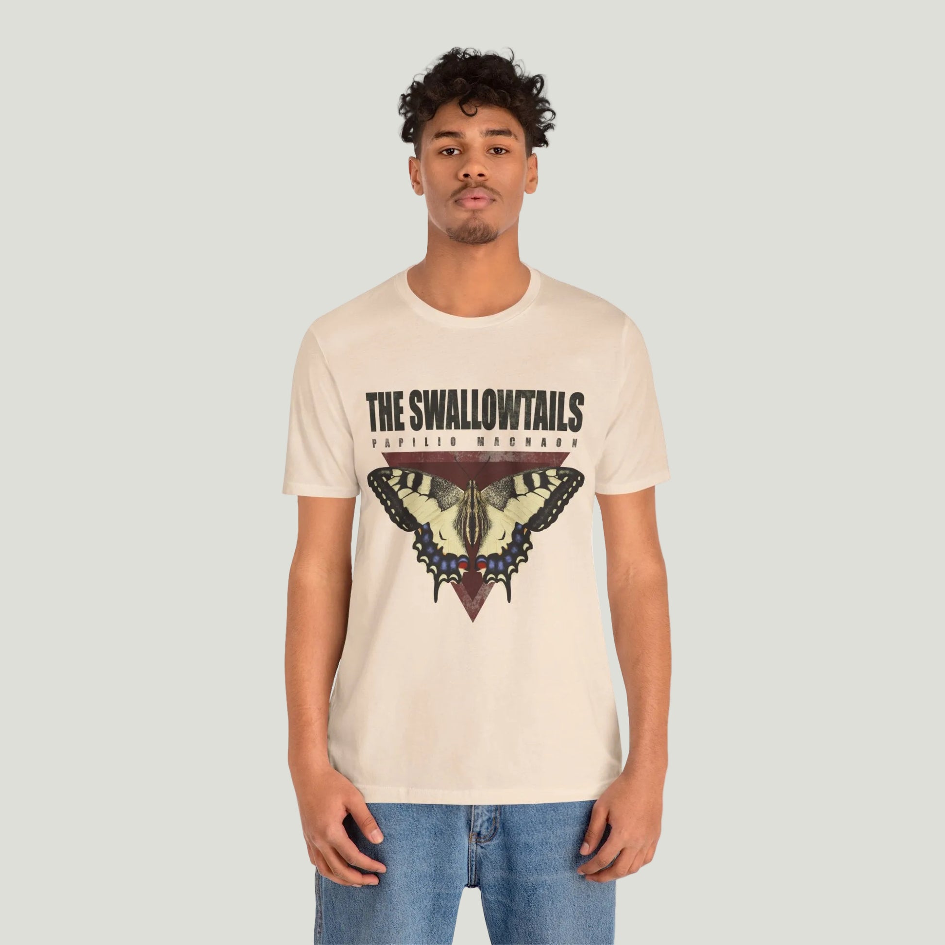 Person wearing a butterfly tee shirt with a graphic design on a white background